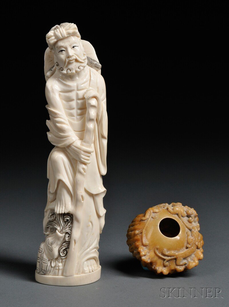 Carved Ivory Figure and Soapstone Water Container,: Carved Ivory Figure and Soapstone Water Container, China, 19th century, depicting a man holding a stick, ht. 8, the warer container depicting chilong at the exterior, lg. 2 3/4 in.