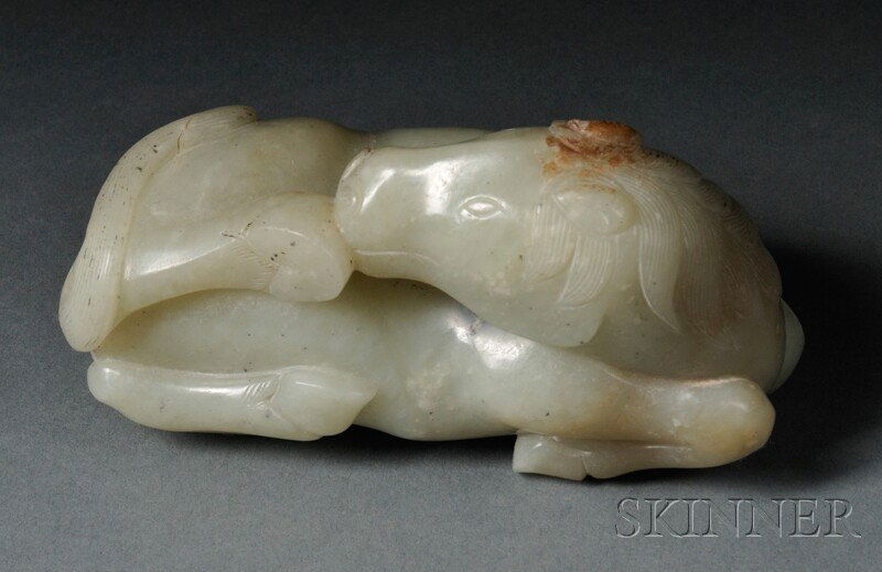 Jade Carving, China, 18th/19th century, of a recum: Jade Carving, China, 18th/19th century, of a recumbent horse, with its head turned to one side cleaning a raised foot, stone of celadon color with a few russet inclusions, lg. 4 3/4 in.