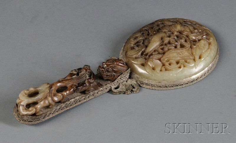 Silver-mounted Jade Mirror, China, 20th century, t: Silver-mounted Jade Mirror, China, 20th century, the handle with a dragon's head carved in relief confronts a chilong crouched along the body, the back of the mirror carved with two cranes with scroll