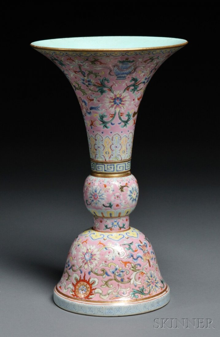 Famille Rose Gu Vase, China, 19th century, fired a: Famille Rose Gu Vase, China, 19th century, fired as two separate pieces, exterior painted with the Eight Auspicious Buddhist Emblems alternating with scrolling lotus flowers on a pink ground, bordered