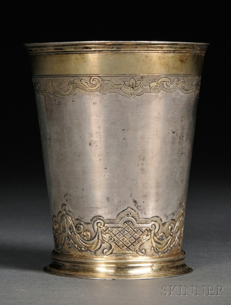 German Silver and Parcel-gilt Beaker, Augsburg, ear: German Silver and Parcel-gilt Beaker, Augsburg, early 18th century, possibly Philipp Stenglin, maker, the cylindrical tapered body on circular flared foot with reeded borders, and engraved with scroll