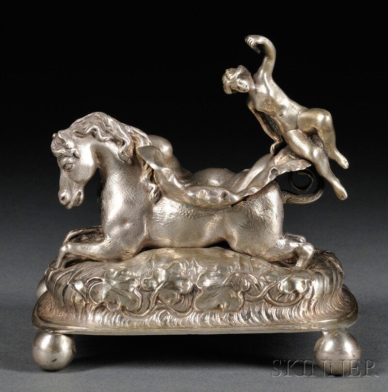 Baroque-style Silver Salt Cellar, Continental, for: Baroque-style Silver Salt Cellar, Continental, formed as a recumbent horse with a shell-form dish on its back and a putto atop the dish, on a naturalistic domed base mounted to four ball feet, lg. 3 3