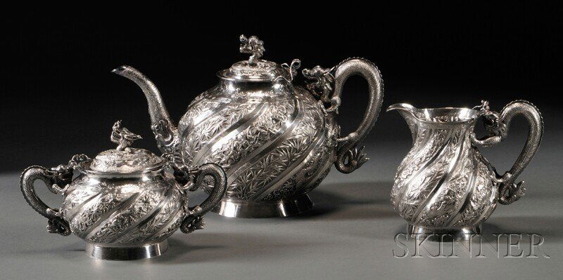 Three-piece Chinese Silver Tea Set, late 19th/earl: Three-piece Chinese Silver Tea Set, late 19th/early 20th century, with character mark, a teapot, covered sugar, and creamer, each with dragon-form handle and bodies with spiraling vertical bands of al