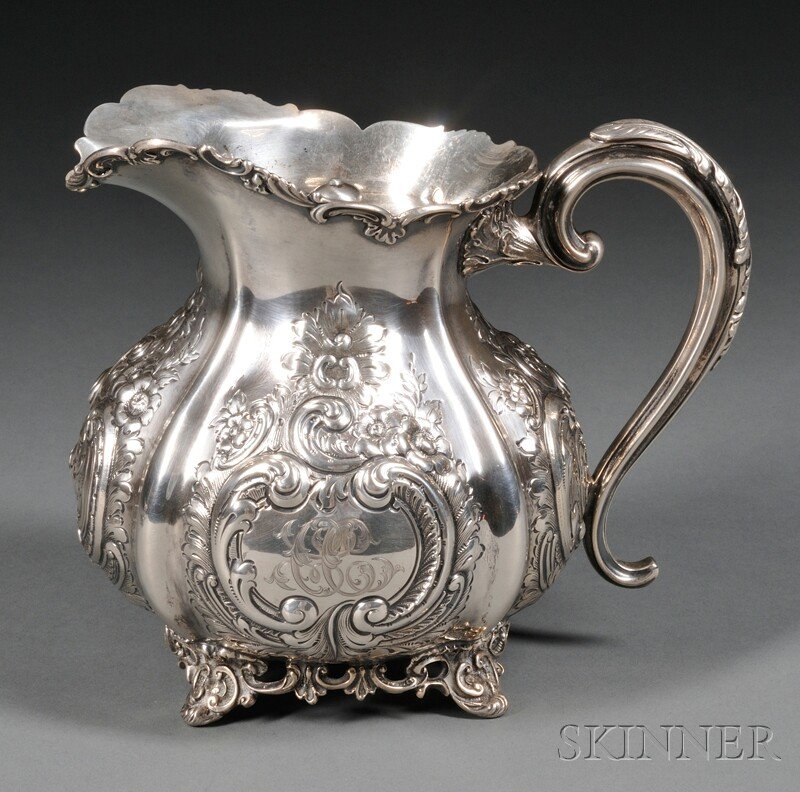 Theodore B. Starr Sterling Silver Water Pitcher, c: Theodore B. Starr Sterling Silver Water Pitcher, c. 1902, squat pear-shaped, chased and embossed with flower and C-scroll cartouches, with C-scroll rim and openwork base with low feet, with removable 