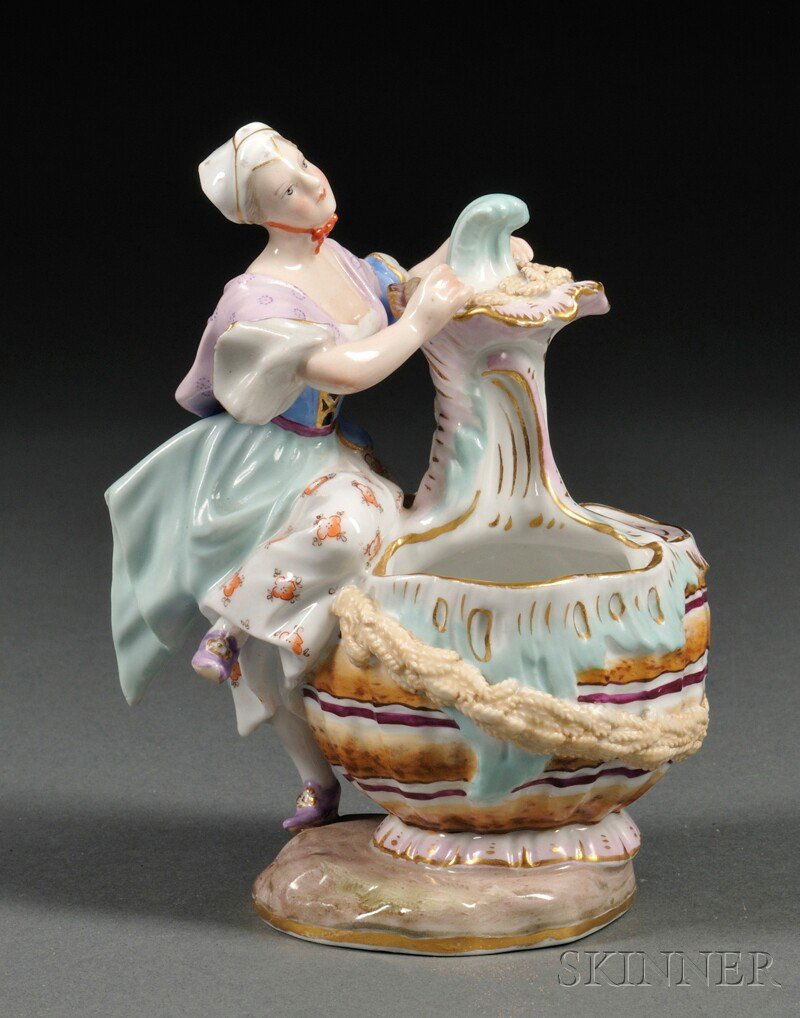 Meissen Porcelain Figural Vase, Saxony, 19th centu: Meissen Porcelain Figural Vase, Saxony, 19th century, polychrome enameled and gilded, modeled as a woman sitting against a large gourd-form basket, on a shaped base, with blue crossed swords mark, inc