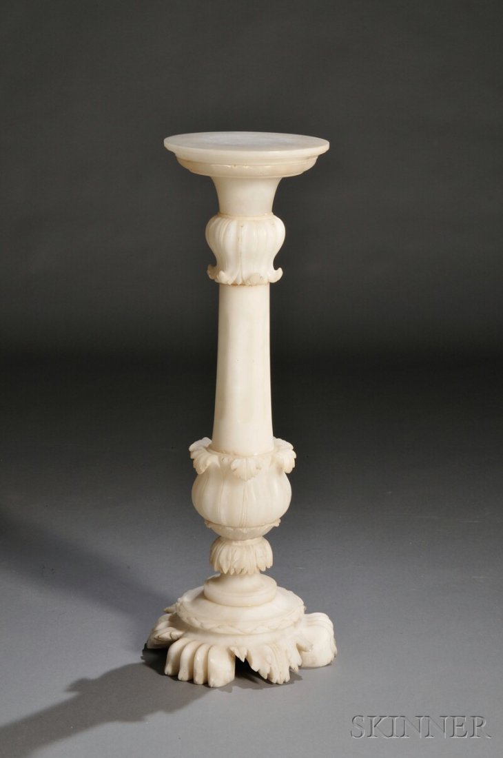 Alabaster Pedestal, circular top on the pedestal w: Alabaster Pedestal, circular top on the pedestal with carved acanthus decoration above and below the fluted column on a base with three acanthus-decorated paw feet, ht. 37 1/4, dia. of top 11 9/16 in.