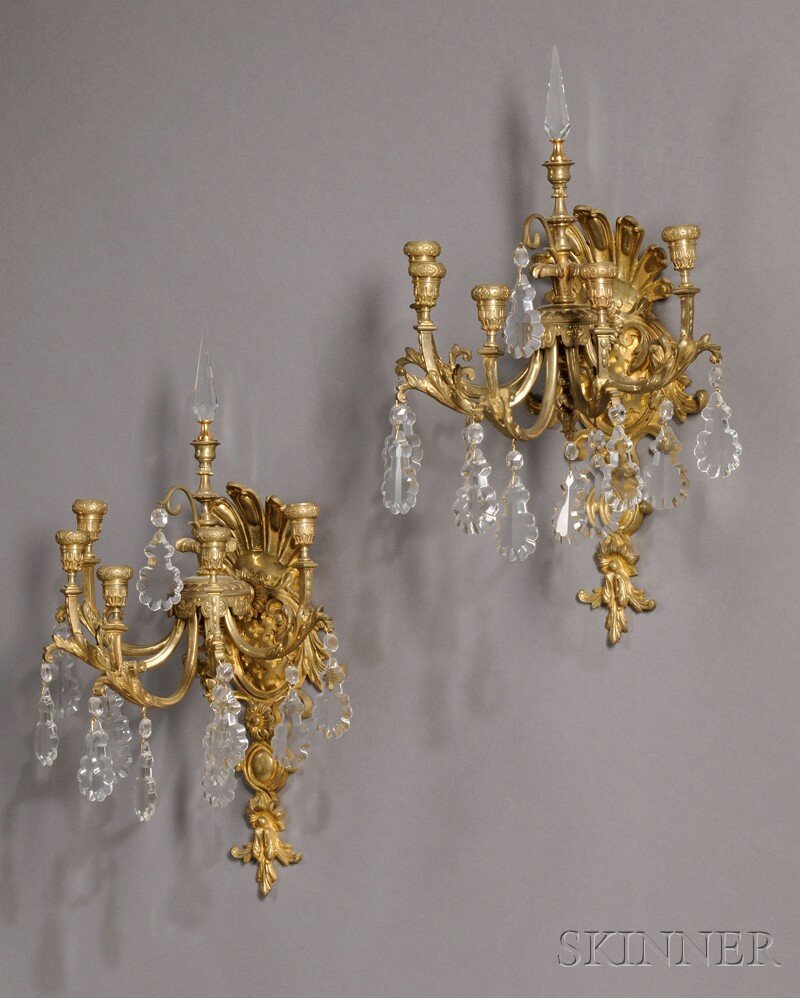 Pair of French Gilt-bronze Wall Sconces, each with: Pair of French Gilt-bronze Wall Sconces, each with five arms and lustres hanging from each arm and central hanging pendant, with central lustre finial on a finely cast gilt-bronze bracket, ht. 22 3/4,