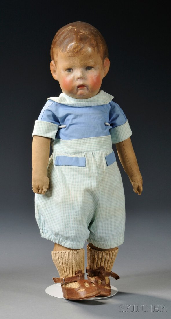 Early Kathe Kruse Boy Doll, Germany, molded cloth h: Early Kathe Kruse Boy Doll, Germany, molded cloth head, painted features, blue eyes, short brown hair, firmly stuffed wide-hip cloth body, cotton romper outfit, brown leather sandals, ht. 16 in. Prove