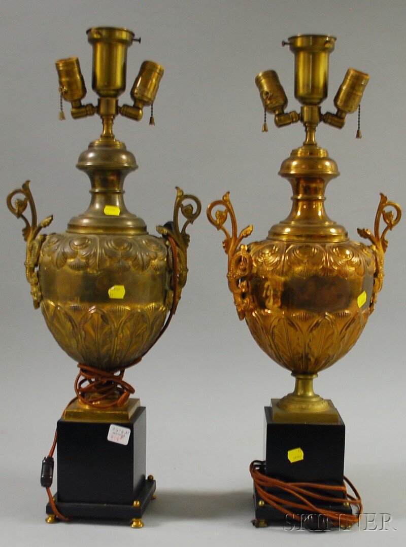 Pair of Empire-style Brass Urn-form Table Lamps, w: Pair of Empire-style Brass Urn-form Table Lamps, with ebonized wood bases, body ht. 20 1/4 in.