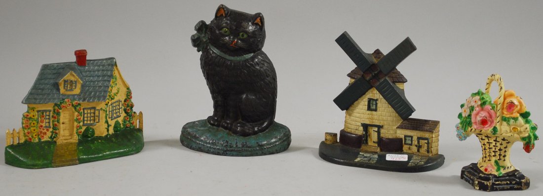 Four Painted Cast Iron Figural Doorstops, a cat, c: Four Painted Cast Iron Figural Doorstops, a cat, cottage, windmill, and basket of flowers.