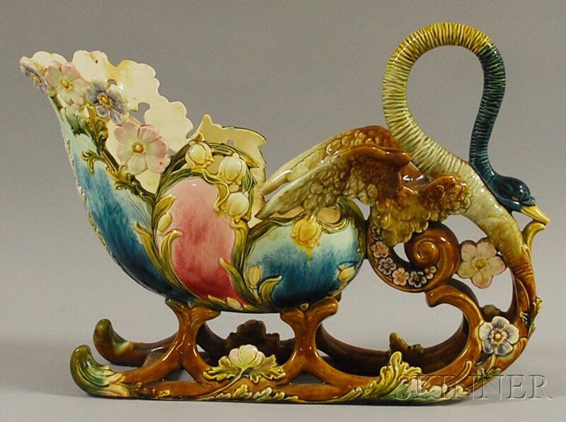 Fantastical Majolica Figural Centerpiece Bowl, com: Fantastical Majolica Figural Centerpiece Bowl, composed of a shell-form floral sled pulled by a swan with outstretched wings, the swan's body morphing into the sled's runners, (cracks, repairs), ht. 1