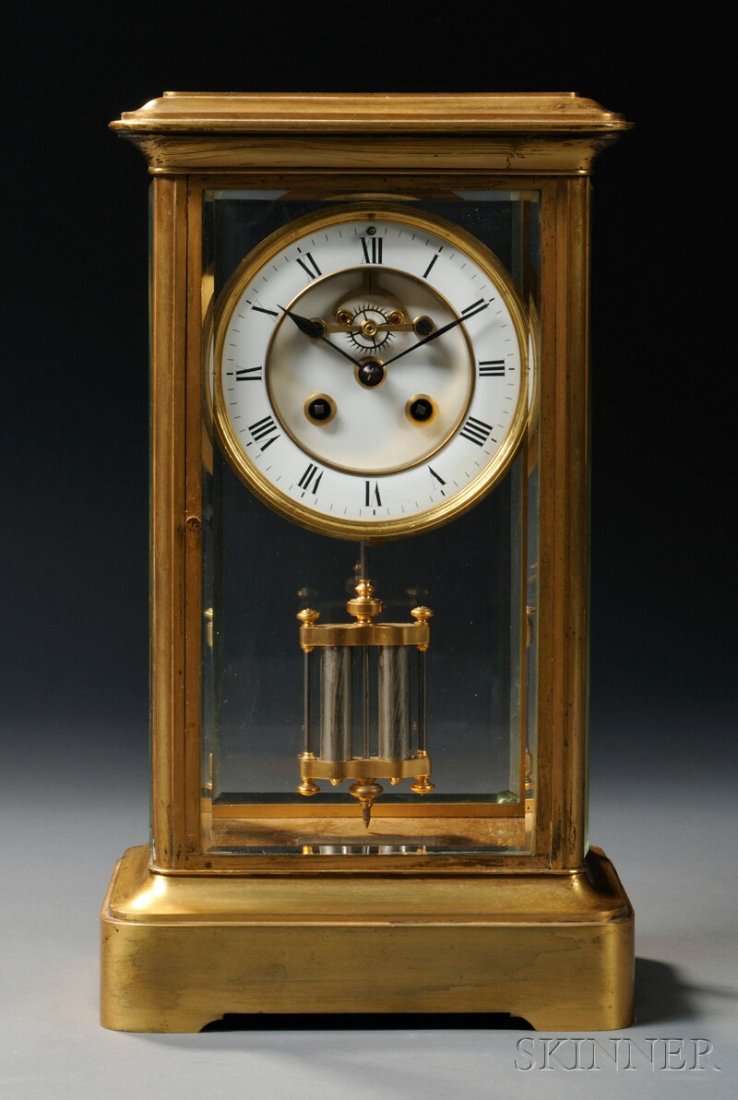 French Gilt-brass and Beveled Glass Mantel Clock,: French Gilt-brass and Beveled Glass Mantel Clock, enamel dial, brass spring-powered movement with mercury pendulum, and with a key, ht. 13 1/2 in.