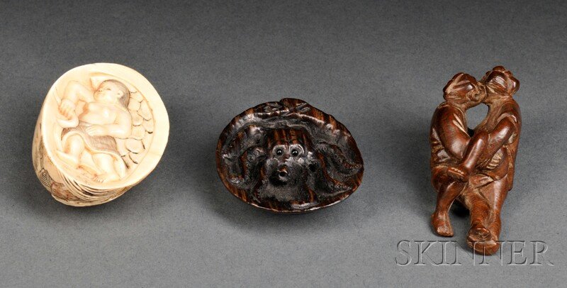 Three Netsukes, Japan, an ivory netsuke carved with: Three Netsukes, Japan, an ivory netsuke carved with a figure on one side, reverse incised with two figures and with rolling waves in relief, lg. 1 7/8; an erotic wood netsuke depicting two figures, lg