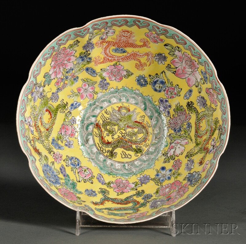 Famille Rose Eggshell Porcelain Bowl, China, the l: Famille Rose Eggshell Porcelain Bowl, China, the lobed body decorated with dragons interspersed with flowers above rolling waves on yellow ground, ruyi border along the rim, six-character Qianlong mar