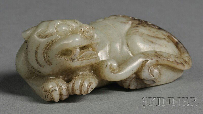 Jade Carving, China, depicting a recumbent mythica: Jade Carving, China, depicting a recumbent mythical animal with its head turned, stone of pale green-gray celadon color, lg. 2 1/2 in.
