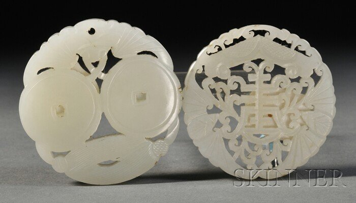 Two Plaques, China, each carved in openwork, one w: Two Plaques, China, each carved in openwork, one with a stylized shou character, the other with bats embracing double cash coins, the stone of celadon-white color, dia. 2, 2 1/8 in.