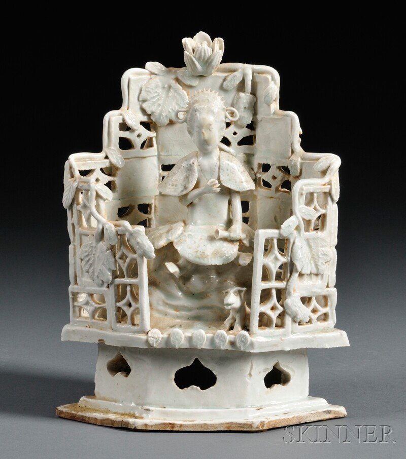 Blanc de Chine Item, China, depicting a deity seat: Blanc de Chine Item, China, depicting a deity seated with a dog at her feet, holding a bottle in her left hand, backed by a screen decorated with foliate design, ht. 9 1/2 in.