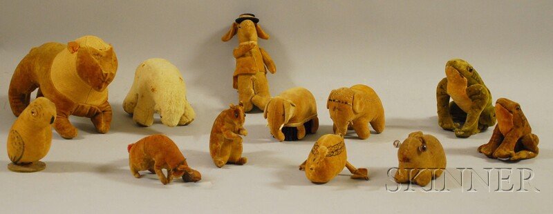 Twelve Assorted Cloth Animal Toy Figures, some wit: Twelve Assorted Cloth Animal Toy Figures, some with painted details and glass eyes, a polar bear, two frogs, a lion, two squirrels, a bird, duck, rabbit, two elephants, and a gentleman rabbit, (imperf