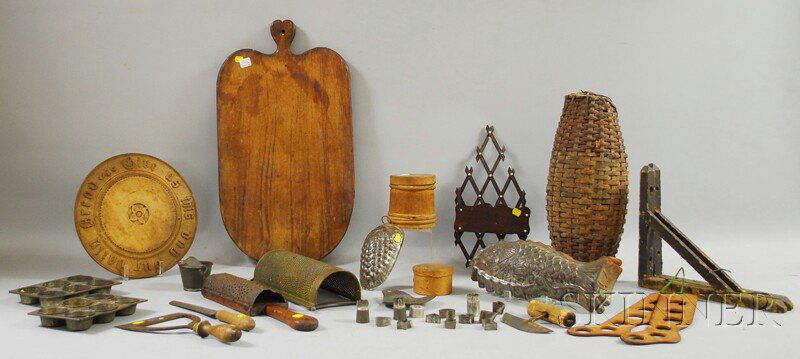 Group of Country Tin, Metal, and Wood Kitchen Item: Group of Country Tin, Metal, and Wood Kitchen Items, two tin culinary molds, two graters, a skimmer, a small pail-form strainer, thirteen small cookie cutters, two choppers, carved maple "Give us this