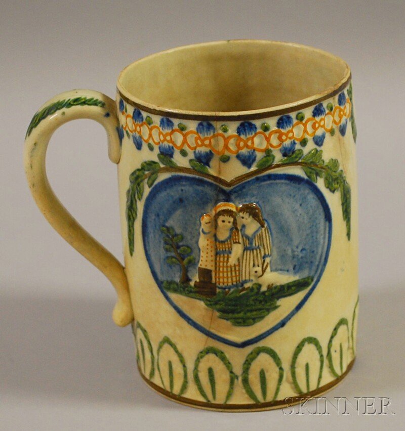 Prattware Polychrome-decorated Mug, depicting chil: Prattware Polychrome-decorated Mug, depicting children at play within a heart-shaped reserve, with foliate borders, ht. 5 7/8 in.