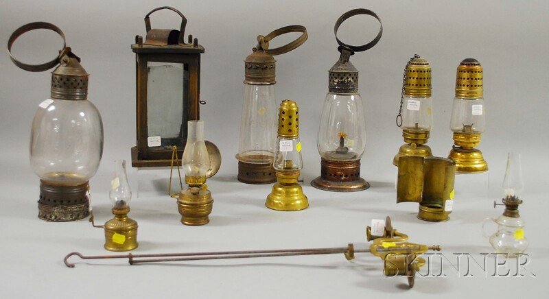 Nine Assorted Metal and Wood Lanterns and Lightin: Nine Assorted Metal and Wood Lanterns and Lighting Devices, including three tin and blown glass lanterns, a wood and glass candle lantern, four brass and glass lanterns, and a brass and steel adjustab