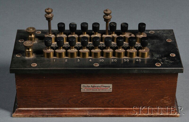 Chicago Apparatus Company Resistance Box, Science: Chicago Apparatus Company Resistance Box, Science Laboratory Equipment, Chicago, Illinois, with a gutta-percha bed, brass resistance plug sockets, and tapered plugs/connectors, all on a mahogany base,