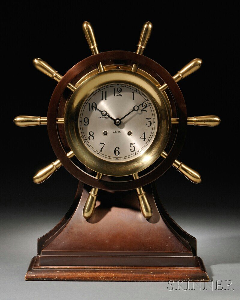 Chelsea "Yacht Wheel" Ship's Bell Clock, Boston, M: Chelsea "Yacht Wheel" Ship's Bell Clock, Boston, Massachusetts, 5 3/4-in. dia. silvered dial with Arabic numerals and marked Chelsea Ship's Bell, patinated bronze metal case with hinged brass bezel, s