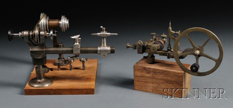 Brass and Steel Rounding-up Tool and a Watchmaker': Brass and Steel Rounding-up Tool and a Watchmaker's Lathe, 19th century Swiss rounding-up tool with a 5 1/2-in. spoked wheel, mounted on a wood block; 10-in. pulley-driven lathe marked Wolf John, with