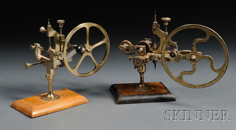 Two Brass and Steel Rounding-up Tools, Switzerland: Two Brass and Steel Rounding-up Tools, Switzerland, 19th century, 6- and 7-in. handwheels with turned wood handles, knurled thumbscrews, cutter assemblies, and horizontal dovetail slides, both mounted