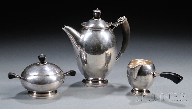 , Jens Sigsgaard Coffeepot, Sugar, and Creamer, Ste: Jens Sigsgaard Coffeepot, Sugar, and Creamer Sterling silver and wood Denmark, 1934 Ebonized wood finials on coffeepot and covered sugar conforming handles on all pieces, silver floral accent on coffe