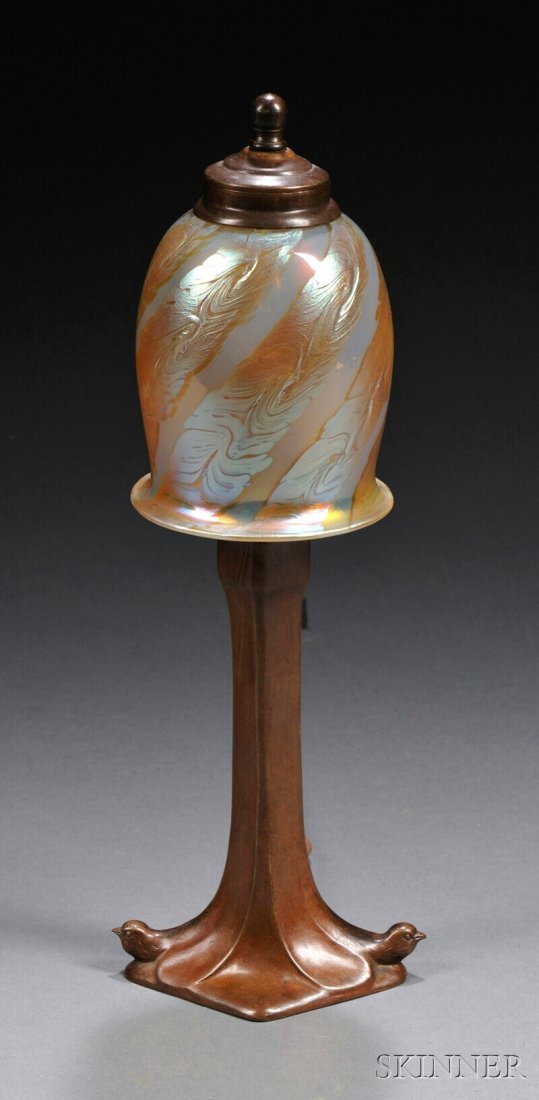 , Art Nouveau Boudoir Lamp, Bronze and art glass,: Art Nouveau Boudoir Lamp Bronze and art glass Possibly Europe, early 20th century Iridescent decorated art glass shade of helmet form, probably Loetz, fitted over a single socket with chain pull, ribb