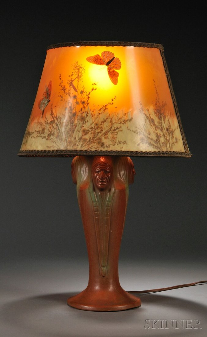 , Van Briggle Pottery Indian Head Lamp with Shade,: Van Briggle Pottery Indian Head Lamp with Shade Pottery and metal Colorado Springs, Colorado, first half 20th century Butterfly and prairie flower decorated clip on shade over single socket, pottery b