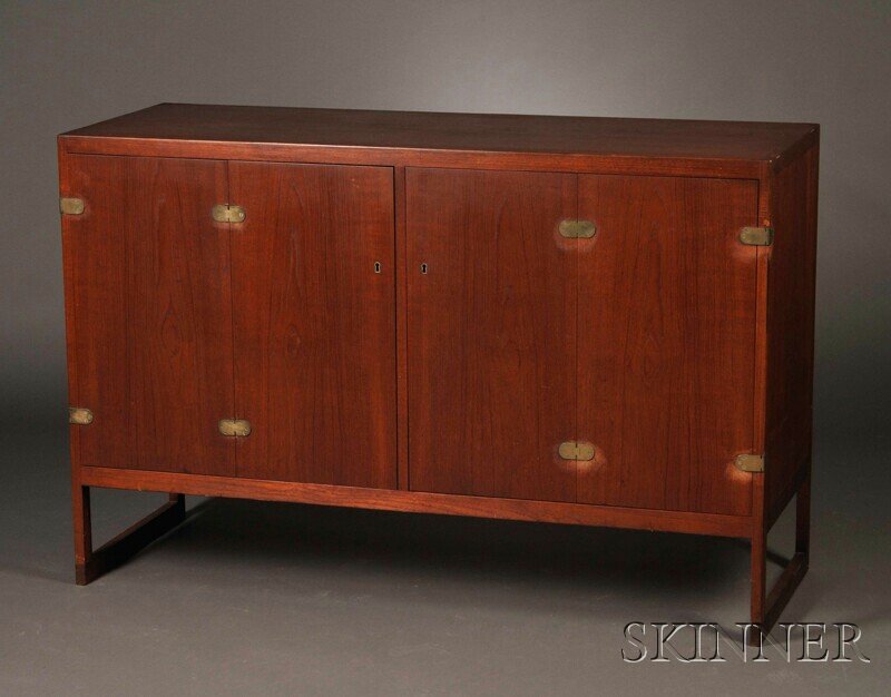 , Teak Sideboard, Teak and brass, Rectangular top: Teak Sideboard Teak and brass Mid-20th century Rectangular top over two bi-folding doors with brass hinges, interior fitted with three adjustable drawers on the left and one adjustable drawer and a sh