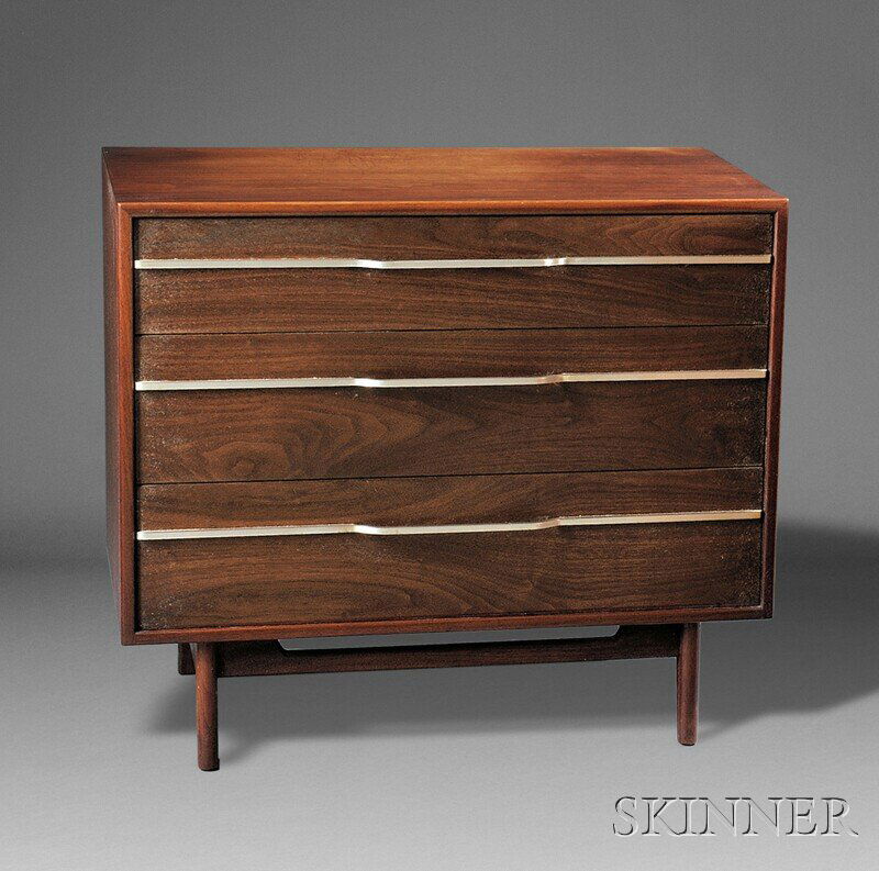 , Jens Risom Chest of Drawers, Walnut and stainles: Jens Risom Chest of Drawers Walnut and stainless steel Mid-20th century Rectangular top over three drawers with stainless steel rods spanning the front and forming handles, on four tapering legs, pape