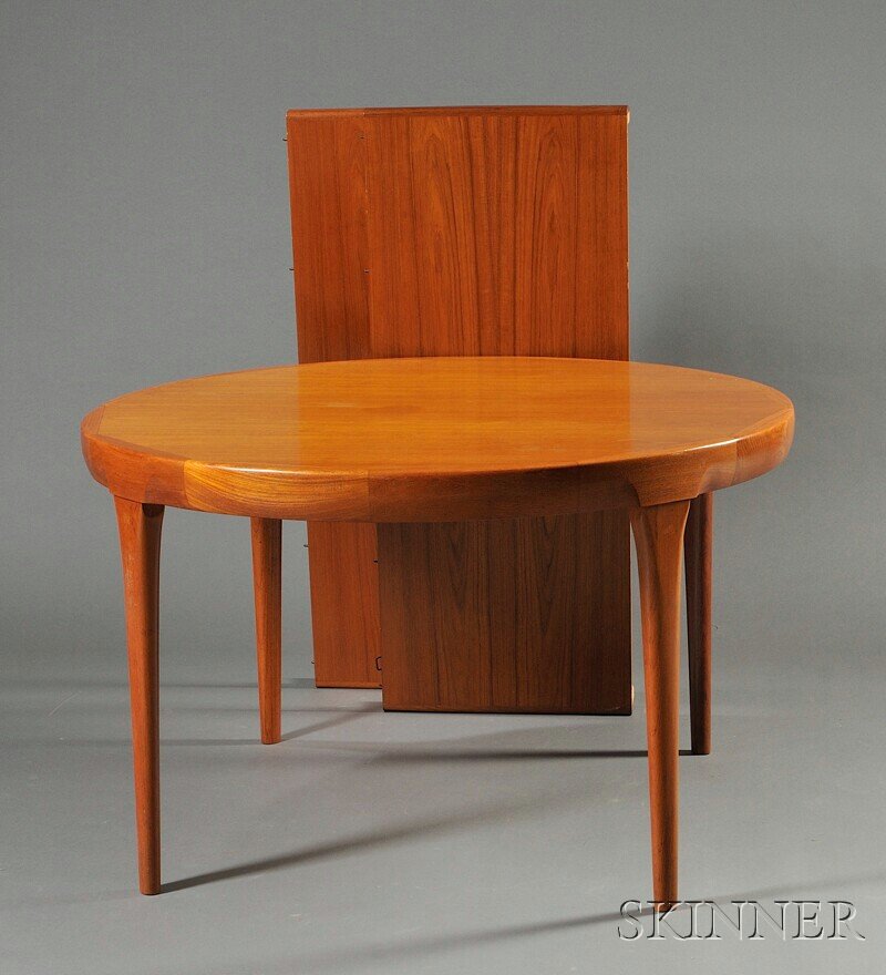 , Ib Kofod-Larsen Designed Dining Table for Farrup: Ib Kofod-Larsen Designed Dining Table for Farrup Mabelfabrik Teak Denmark, mid-20th century The circular top with wide banding over four tapered legs, with two extension leaves, bearing metal manufact