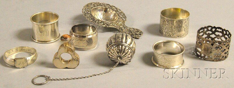 Nine Small Silver Articles, a Continental silver t: Nine Small Silver Articles, a Continental silver tea strainer, a Simons Bros. sterling tea ball, a Mexican sterling cologne with agate-inlaid stopper, and six napkin rings, one with English marks, two