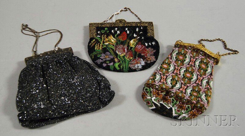 Three Antique Beaded Purses, one with solid metall: Three Antique Beaded Purses, one with solid metallic charcoal-colored beads and a tarnished silver-tone frame, one with colorful geometric design, and one with floral pattern, all with ornate frames,
