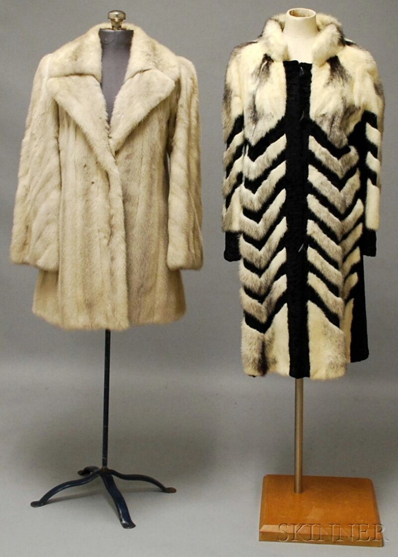 Two Fur Coats Including a Black and White Art Deco: Two Fur Coats Including a Black and White Art Deco-style Fur and Lamb's Wool Coat, with chevron pattern and triangular buttons, approx. size medium; and a mid-length grayish-white fur coat with slight