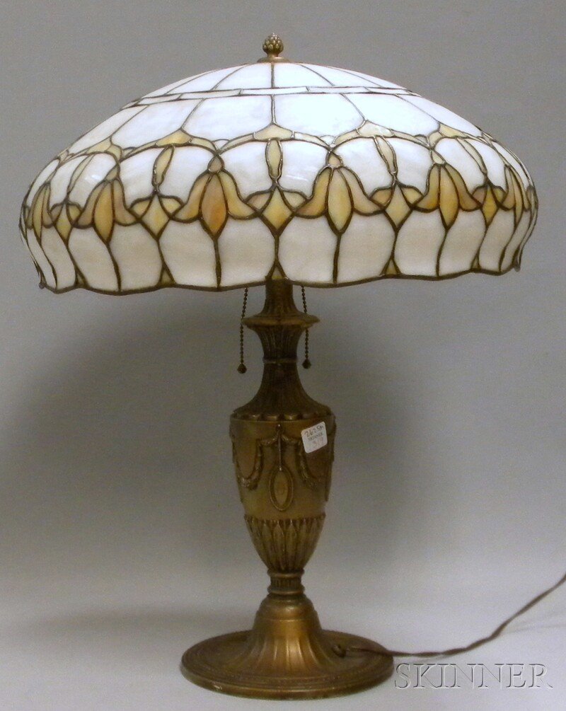 Leaded Slag Glass Shade with a Painted Cast Metal: Leaded Slag Glass Shade with a Painted Cast Metal Table Lamp Base, the base with three sockets and belted ball chain pulls, shade dia. 19, base ht. 23 1/2 in.
