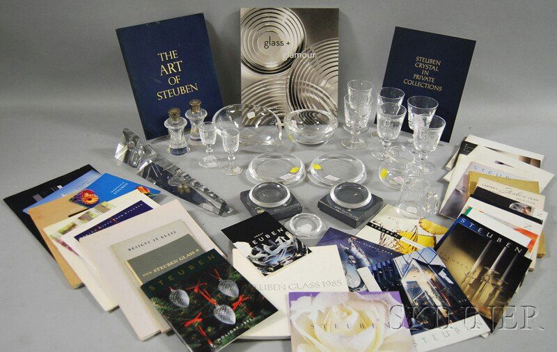 Twenty Pieces of Steuben Colorless Art Glass Tabl: Twenty Pieces of Steuben Colorless Art Glass Table Items and Related Books, including a pair of shakers, six liquor stems, a pair of cordials, a creamer, cup, bowl, ashtray, obelisk, two shallow dishe