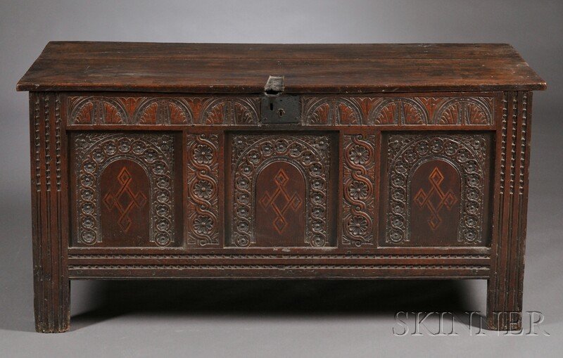 Jacobean-style Carved and Inlaid Oak Coffer, hinge: Jacobean-style Carved and Inlaid Oak Coffer, hinged lid above a triple-paneled arched carved front, each arch with an inlaid diamond pattern, raised on fluted supports, ht. 29, wd. 57 3/4, dp. 22 1/2 