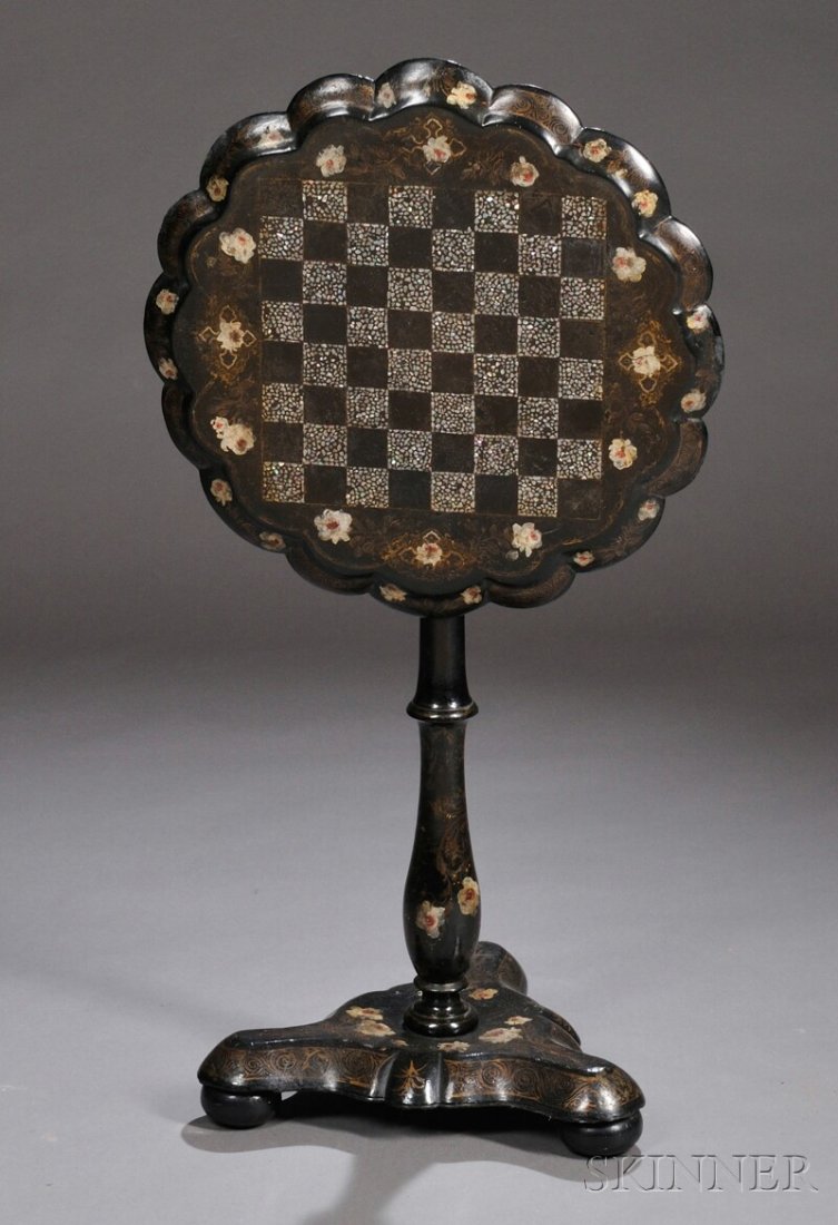 Victorian Papier-mache Tilt-top Games Table, Engla: Victorian Papier-mache Tilt-top Games Table, England, mid-19th century, the circular top with molded and scalloped edge and mother-of-pearl inlaid checkerboard bordered by polychrome and gilded flower