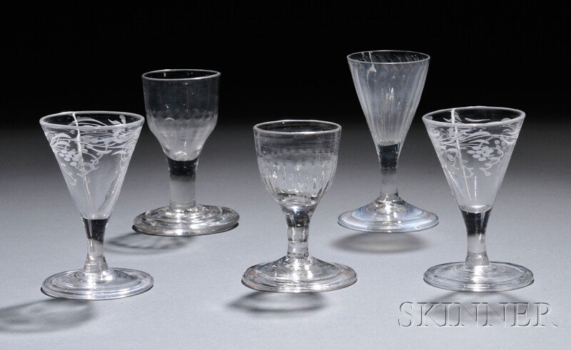 Five Dram Glasses on Plain Stems, England, 1740-50: Five Dram Glasses on Plain Stems, England, 1740-50, three with molded bowls: one with fluted funnel bowl and conical foot with folded rim, ht. 4 1/8, one with ogee bowl on foot with three incised conc