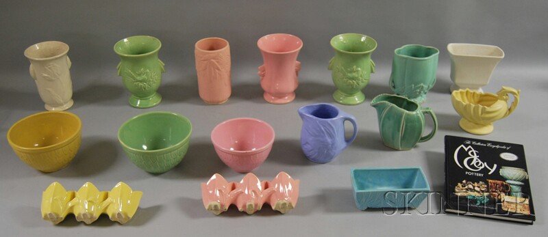 Collection of McCoy Art Pottery and a McCoy Potter: Collection of McCoy Art Pottery and a McCoy Pottery Collector's Book, including three mixing bowls, seven vases, two pitchers, a footed bowl with handle, and three planters, ht. to 8 1/4 in.