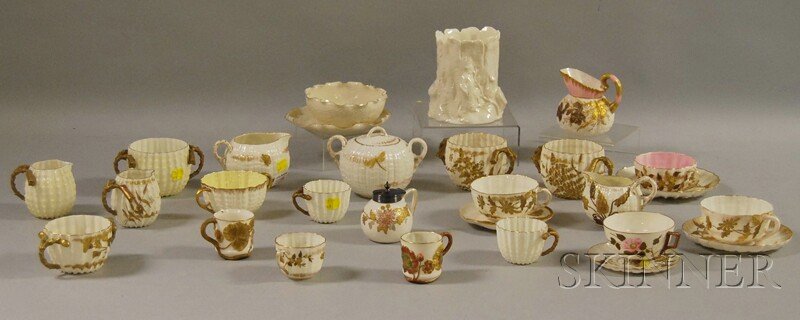 Twenty-eight Pieces of Ott & Brewer Belleek Gilt a: Twenty-eight Pieces of Ott & Brewer Belleek Gilt and Enameled Porcelain Tableware, including seven assorted cups, four cup and saucers, a condiment jar, two creamers, an open sugar bowl and creamer, a