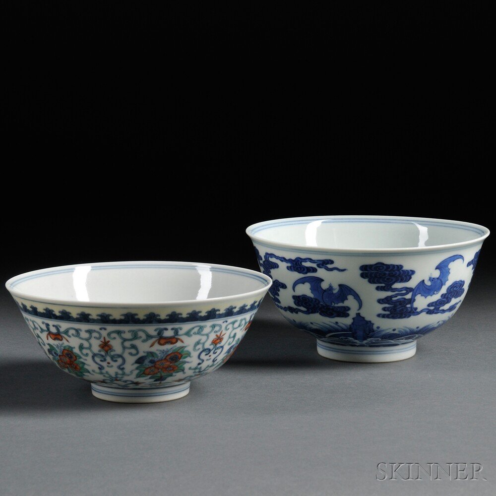 Two Porcelain Bowls, China, 20th century, a blue an: Two Porcelain Bowls, China, 20th century, a blue and white bowl decorated with bats flying amongst clouds over rolling waves, the interior well painted with a shou character within a double ring and a