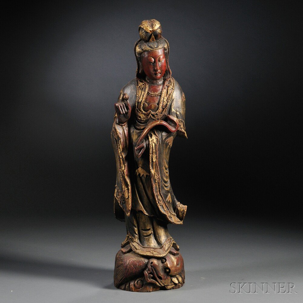 Lacquered Guanyin, China, 19th/20th century, woode: Lacquered Guanyin, China, 19th/20th century, wooden statue standing on a base decorated with carved dragon, holding a ruyi scepter and a precious jewel in her hands, ht. 33 1/2 in.