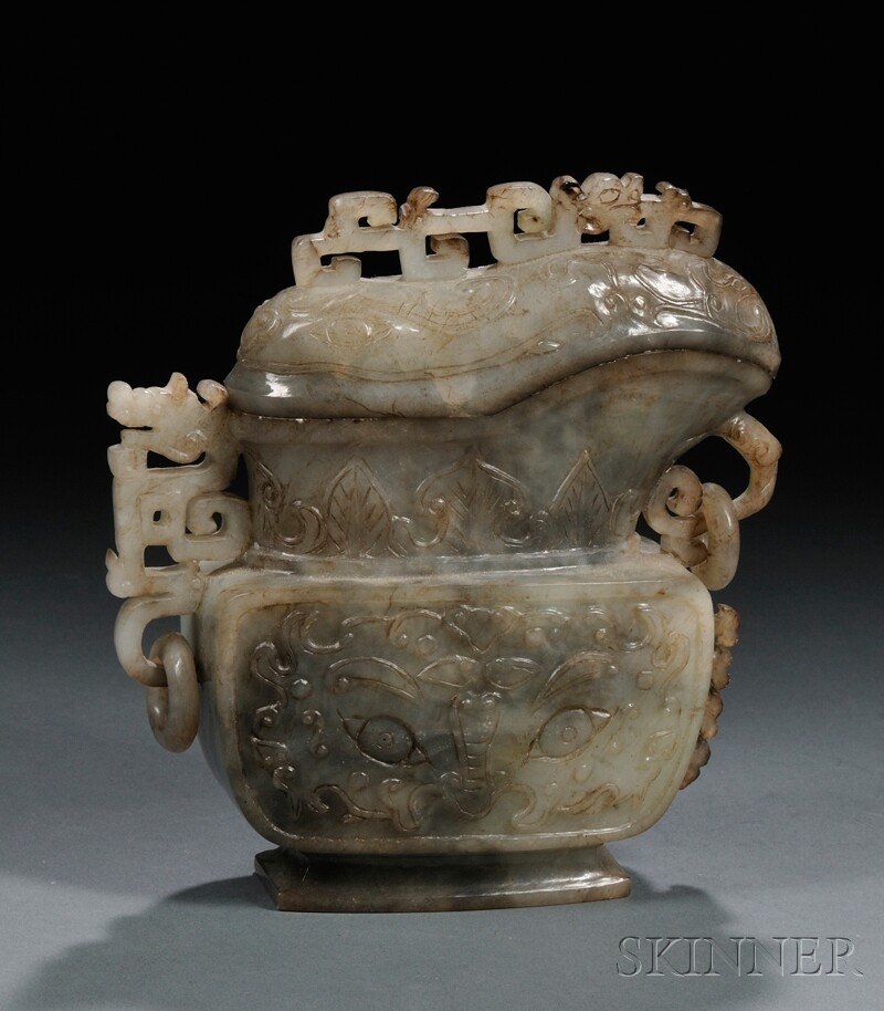 Archaistic Hardstone Ewer, Yi, China, 19th century: Archaistic Hardstone Ewer, Yi, China, 19th century, the midsection carved with taotie mask and the neck decorated with a band of upright ruyi-shaped leaves, resting on a short spreading foot