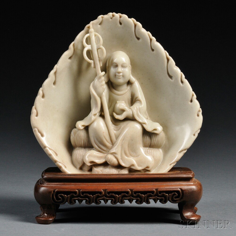 Soapstone Plaque with Stand, China, 19th/20th cent: Soapstone Plaque with Stand, China, 19th/20th century, depicting Ksitigarbha with medicine bowl and monk's staff, seated on double lotus throne, placed on a wooden stand with openwork design, ht. 7 5/
