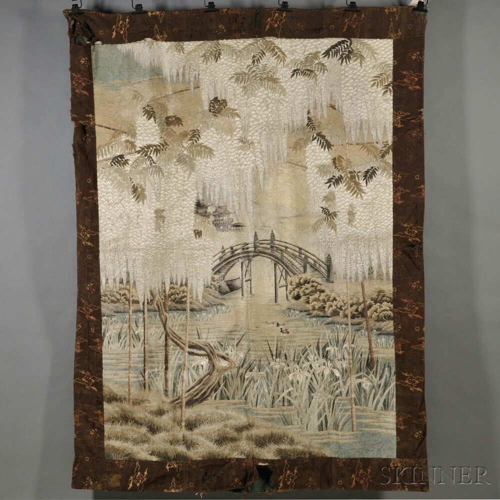 Embroidered Wall Hanging, Japan, 19th/20th century: Embroidered Wall Hanging, Japan, 19th/20th century, framed in a border of silk strips, depicting a natural scene, with a pond with grasses, irises, and willows with an arched bridge and temples in dis